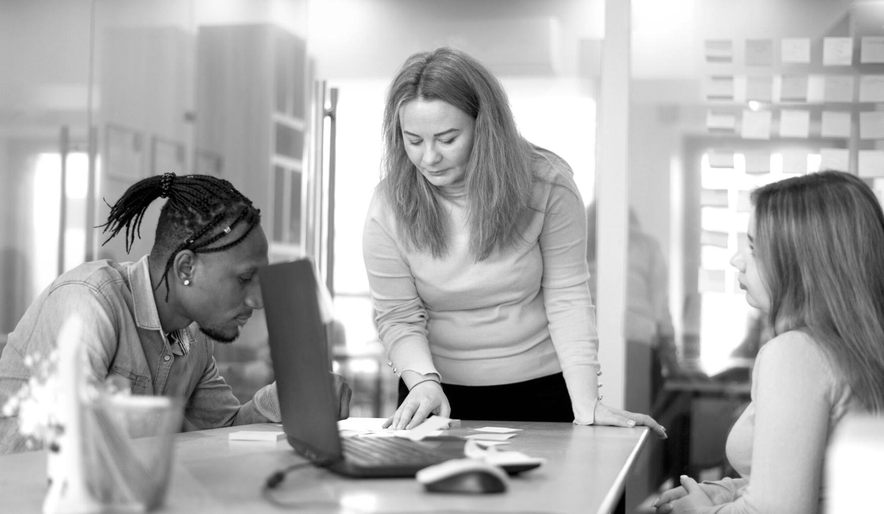 Security testing team analyzing vulnerability assessment results on multiple monitors in modern cybersecurity operations center